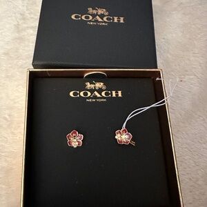 NEW COACH PIERCED EARRINGS. RED GOLD